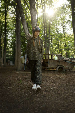 Female paintball player on playground in forestの写真素材