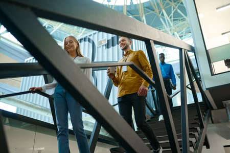 Team of happy managers on stairs in IT officeの写真素材