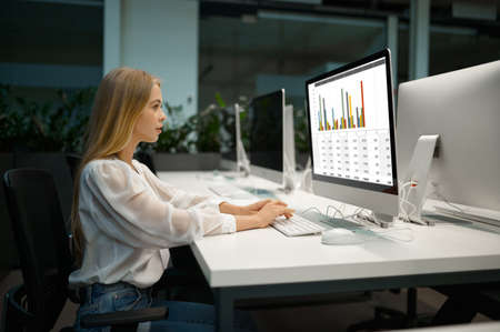 Female manager works on computer, IT officeの写真素材