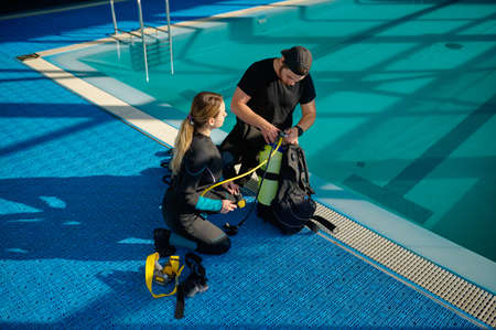 Male instructor explains how scuba gear works