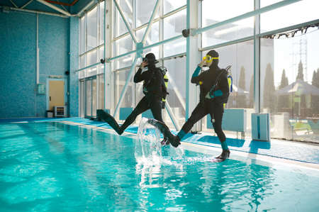 Woman and male divemaster, course in diving schoolの写真素材