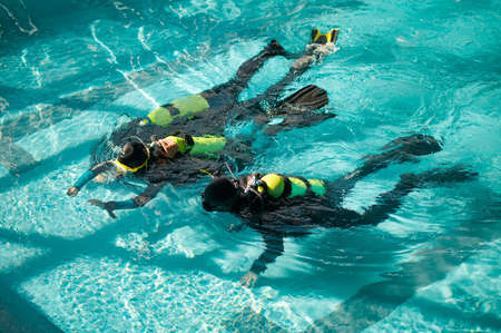 Divemaster and divers in aqualungs, dive courseの写真素材