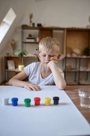 Little boy drawing with gouache, kids in workshopの写真素材