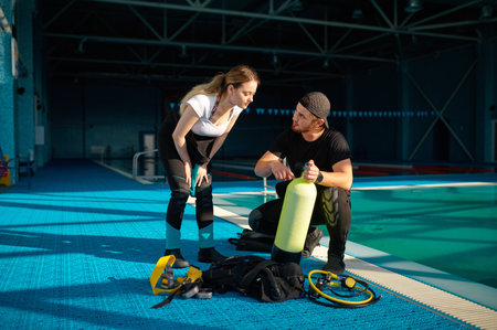 Male instructor explains how scuba gear worksの写真素材