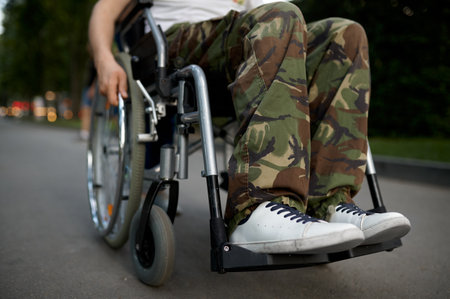 Young male person in wheelchair, view on legsの写真素材