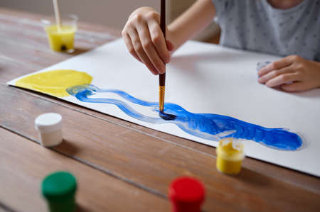 Girl drawing with brush and gouache, art schoolの写真素材