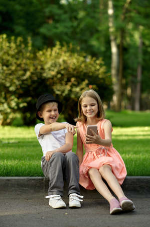 Childrens romantic meeting in summer parkの写真素材