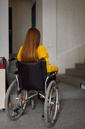 Disabled female student in wheelchair at stairsの写真素材