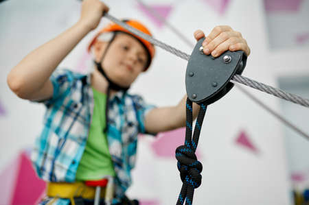 Little boy on zip line, young climber in helmetの写真素材