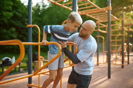 Father and son doing exercise, sport training