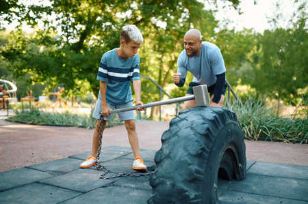Father and son, crossfit training on playground