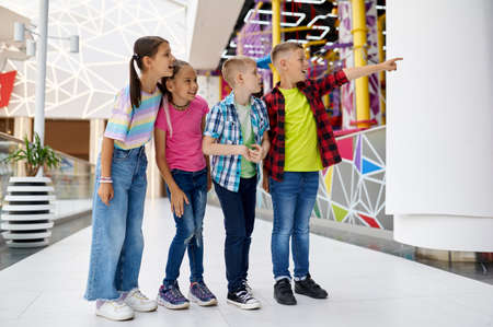 Cheerful children walking in entertainment centerの写真素材