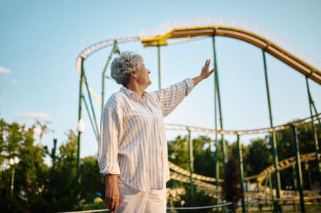Pretty granny poses in summer amusement parkの写真素材