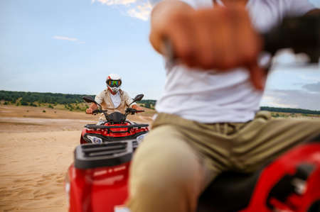 Two travelers, atv riding in desert sands