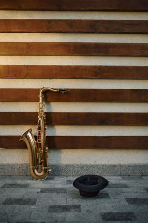 Galden saxophone and begging hat at the wallの写真素材