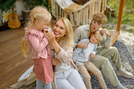 Cheerful family resting at the motorhome, campingの写真素材