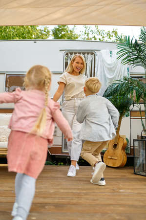 Mother and children play at the trailer, campingの写真素材