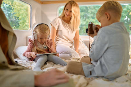 Family with kids relaxing in motorhome, campingの写真素材