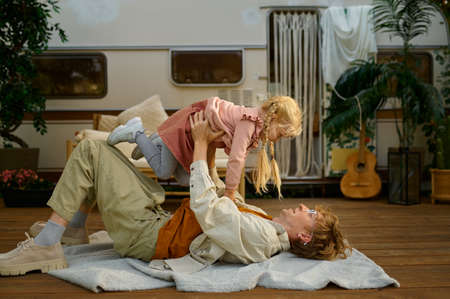 Daddy and gaughter play on terrace at the trailerの写真素材