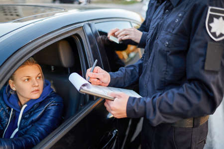Police patrol checking drivers license of driver