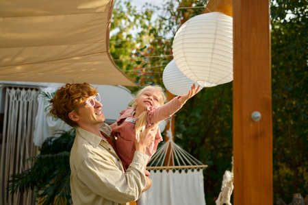 Daddy and gaughter poses at the trailer, campingの写真素材