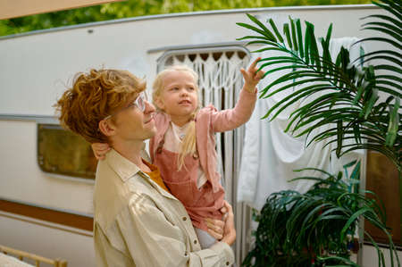 Father and gaughter having fun at trailer, campersの写真素材