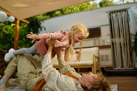 Daddy and gaughter play on terrace at the trailerの写真素材