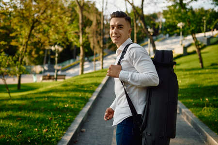 Young saxophonist holds saxophone in caseの写真素材