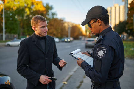 Police checking the drivers license from driver