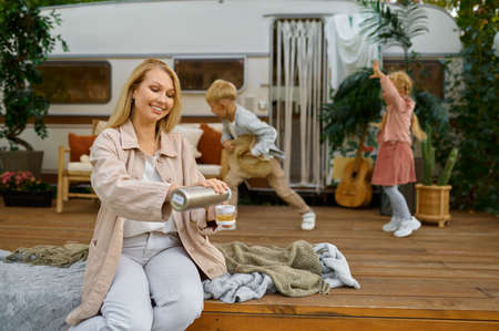 Mother and children drink tea at the trailerの写真素材