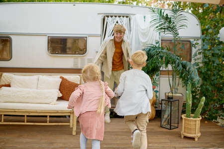Father and children play at the trailer, campingの写真素材