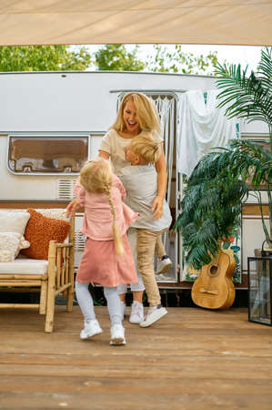 Mother and children play at the trailer, campingの写真素材