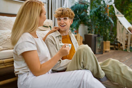 Love couple resting at the trailer, summer campingの写真素材