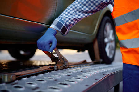 Closeup tow truck driver hand fixing carの写真素材