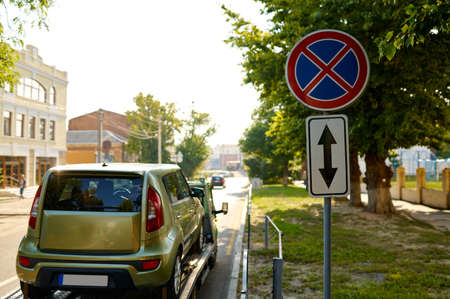 Improper parked car evacuation by tow truck