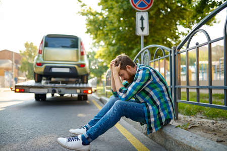 Unhappy man and incorrect parked car evacuationの写真素材