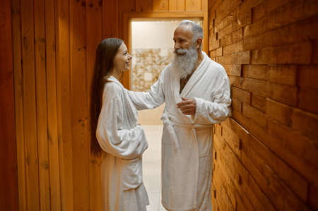 Man and woman talking in spa saunaの写真素材