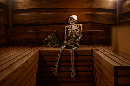 Skeleton steaming with oak broom in sauna