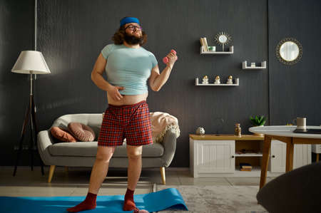 Funny man doing morning workout with dumbbells