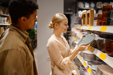 Happy loving couple family choosing new kitchenwareの写真素材