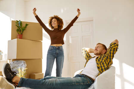 Happy couple rejoicing moving to new houseの写真素材