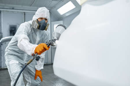 Technician in safety clothing spraying car paintの写真素材