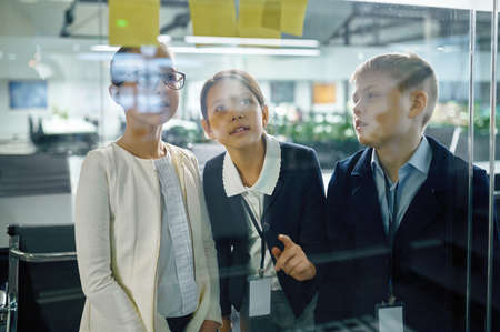 Children business team talking at glass board