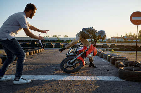Student falls off a motorbike, motorcycle schoolの写真素材