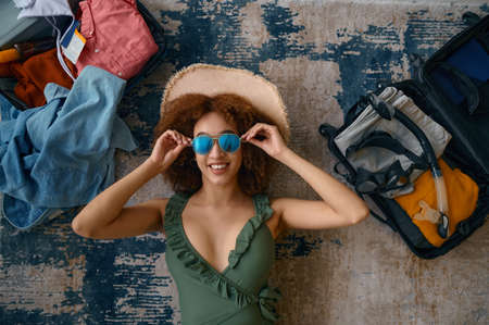 Delighted young woman dreaming about summer vacationの写真素材