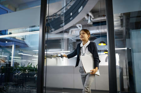 Business girl entering conference room with smile