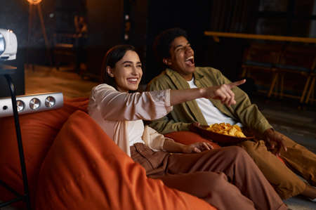 Family couple watching comedian film on projectorの写真素材