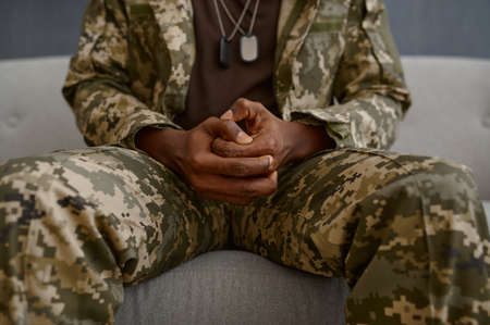Closeup hands of soldier in military uniformの写真素材