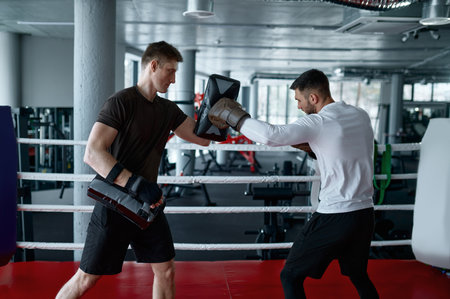 Boxer practicing with personal trainerの写真素材
