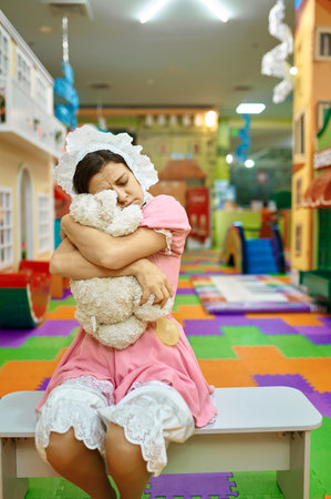 Sad woman baby hugging teddy bearの写真素材